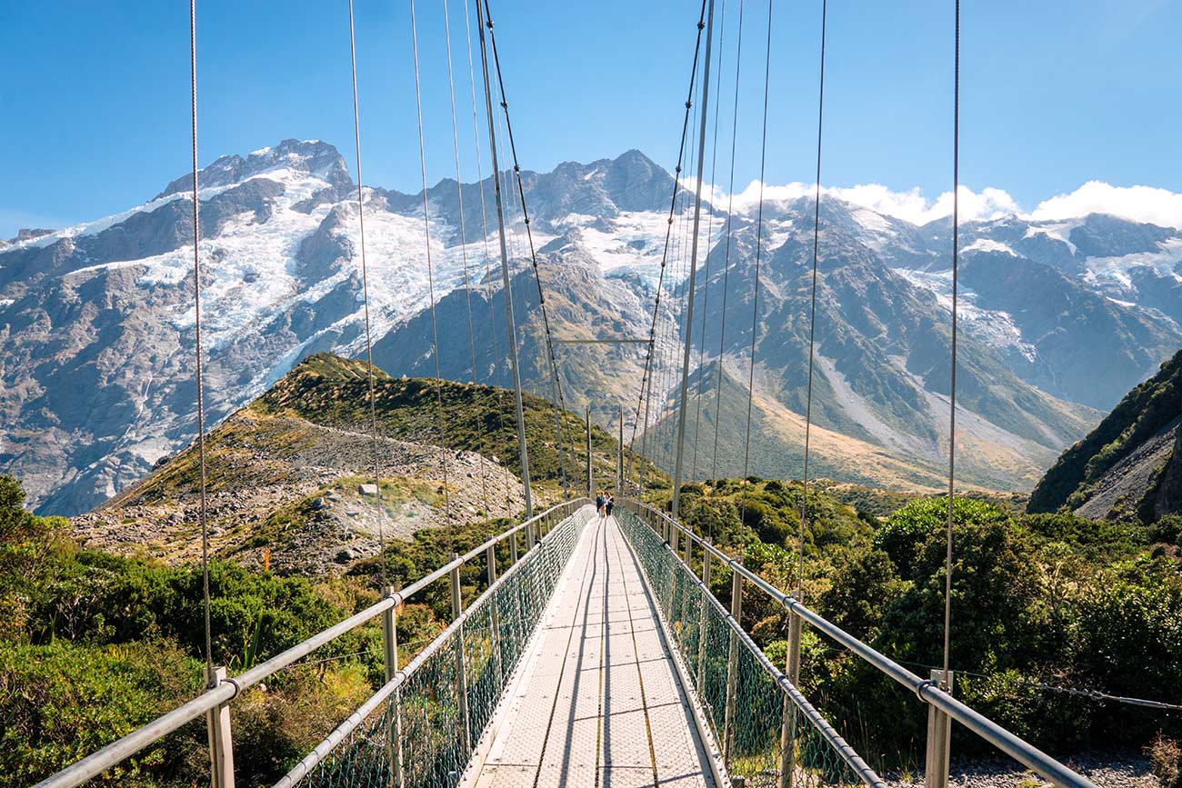 Swing bridge on the Hooker Valley Track in Mount Cook. The ultimate New Zealand bucket list - top 50 things to do